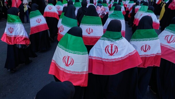 Women draped in Iranian flags march during the state-organized "Janfada," or "Sacrifice for Iran," military-style parade in Tehran, Iran, on Sept. 18, 2026.
