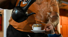 Yodite Mengesha serves Ethiopian coffee from a jebana at Abugida Restaurant. Frankincense, burning at the right, helps set the atmosphere. A traditional coffee ceremony will be part of Saturday's celebration.