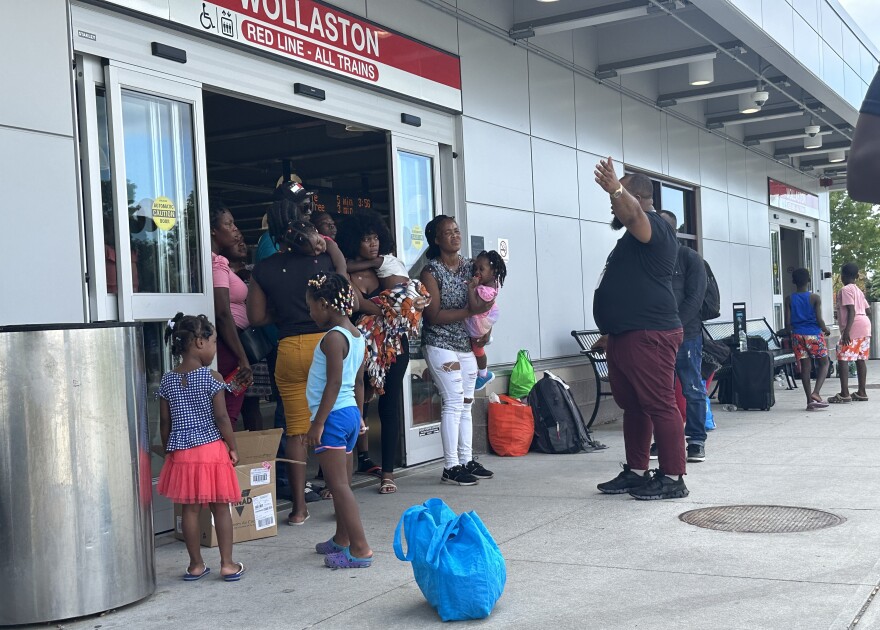 A group of migrant families listen to an organizer from Immigrant Family Services Institute.