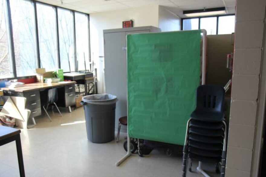Extra chairs and desks are stacked in room at the end of the charter school’s floor. A barrier made of PVC pipe and paper blocks other stored supplies. The special education teacher also meets with students in this room. (Photo by: Katie Anastas/Alaska Public Media)