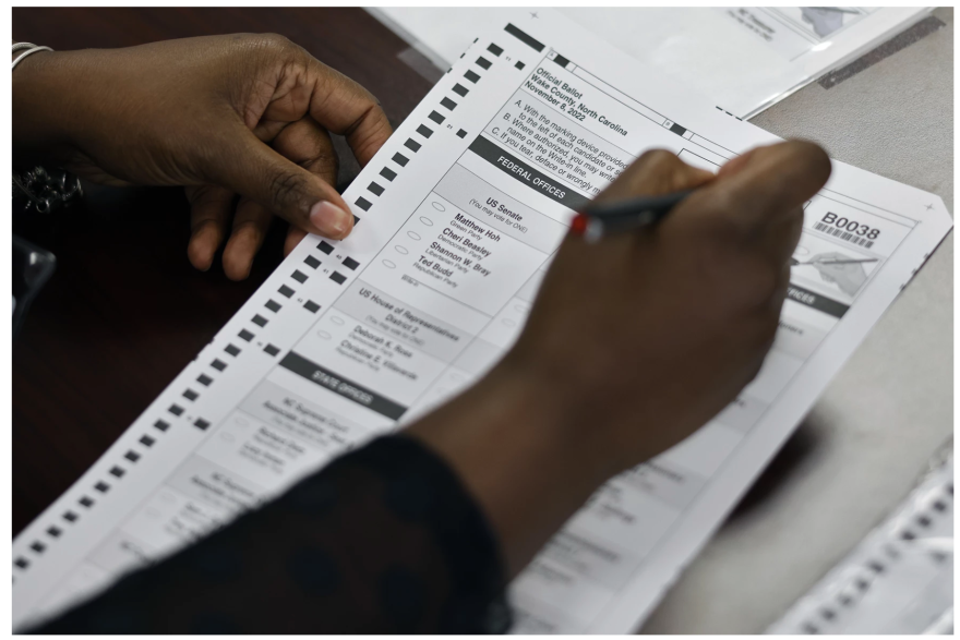 An election worker prepares an absentee ballot request at the Wake County Board of Elections office in Raleigh on Thursday, Sept. 15, 2022.