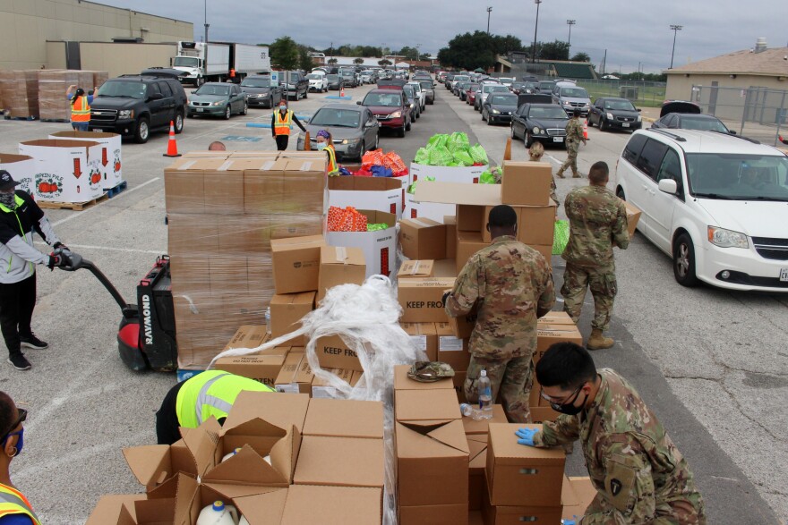 Tarrant Area Food Bank workers hand out groceries at Herman Clark Stadium in Fort Worth on Friday, September 11, 2020.