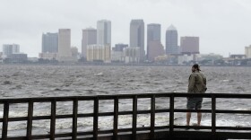 FILE - Ash Dugney views Tampa Bay on the Ballast Point Pier ahead of Hurricane Ian