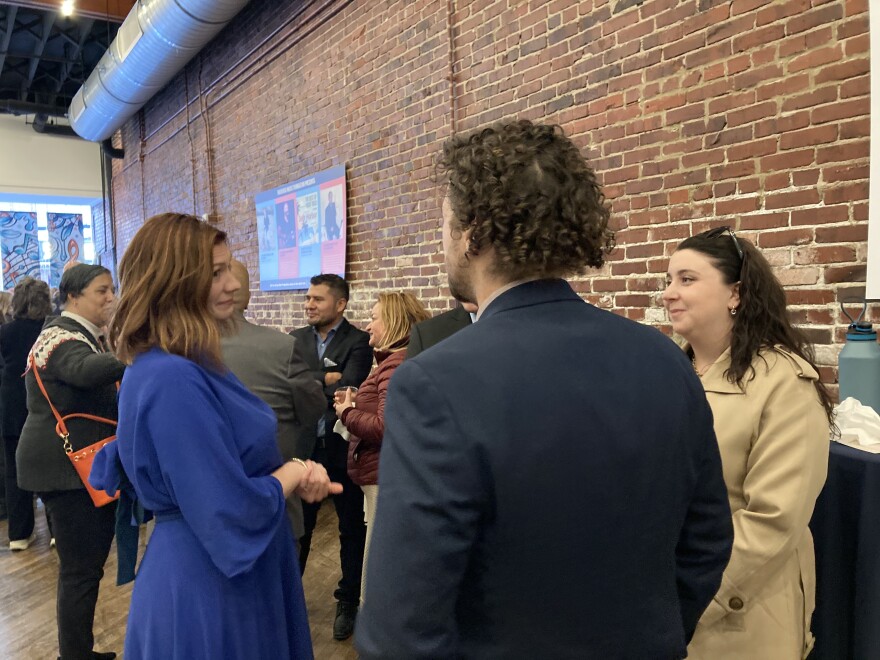First time Council Member Libby Taylor (blue dress) speaks with residents after the inauguration
