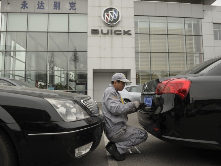 A mechanic works on a Buick at a General Motors dealership in Shanghai last December. GM just announced it plans to open 600 additional dealerships in China. The company now sells more cars in China than it does in the United States.