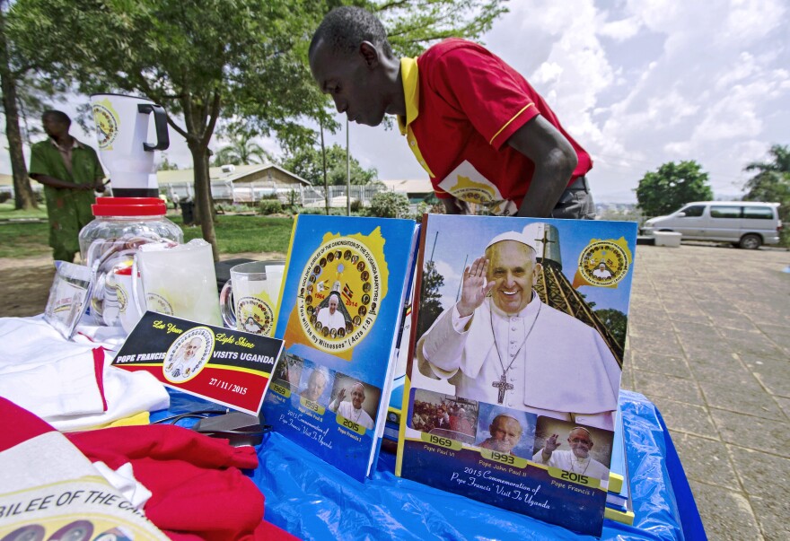 A vendor arranges portraits of Pope Francis outside the Lubaga Cathedral in Kampala, Uganda, in preparation for the papal visit.