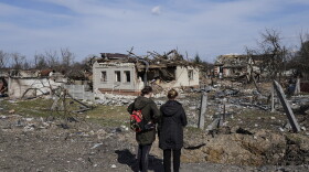 Women look at houses damaged by shelling in Chernihiv, Ukraine, Thursday, April 7, 2022. Ukraine is telling residents of its industrial heartland to leave while they still can after Russian forces withdrew from the shattered outskirts of Kyiv to regroup for an offensive in the country's east. (Evgeniy Maloletka/AP)