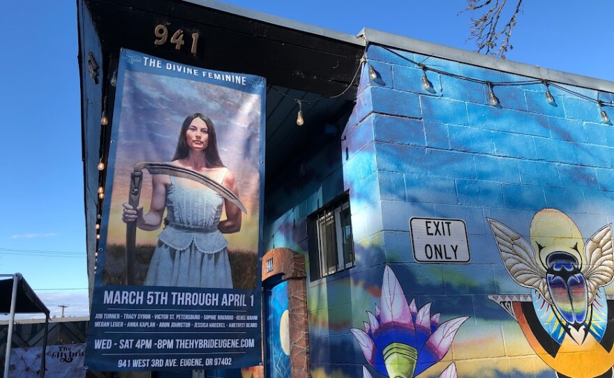 Art pieces at The Hybrid for "The Divine Feminine"; events manager Kathryn Albert. 