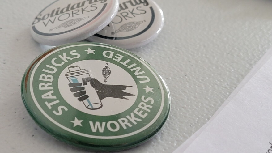 Starbucks Workers United pins sit in the Buffalo office of Starbucks Workers United Feb. 23, 2022.