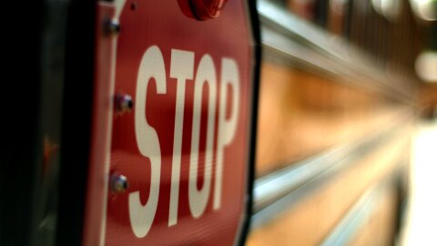 A stop sign on a school bus.