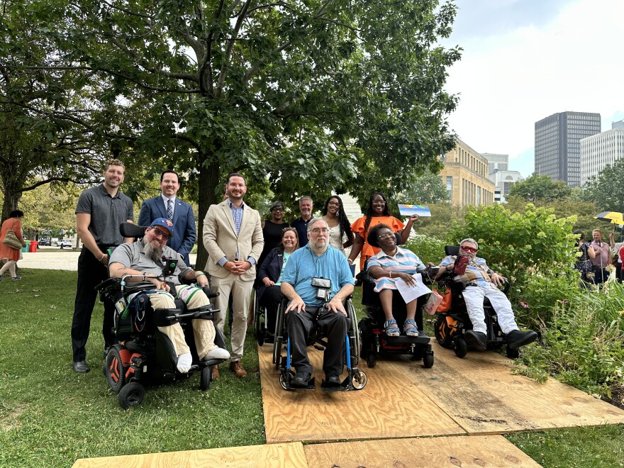 Advocates, city and county officials pose for a photo after the Disability Pride flag raising in Niagara Square on July 25, 2025.