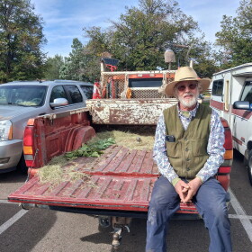 David Temple sits in an empty truck bed after handing out trees at the Cortez Public Library.