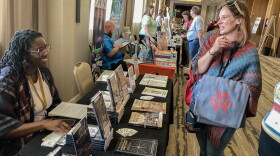 Garicka Hill, left, co-founder of PLPG Publishing, talks with Sammy Herzberg, director of the Oskaloosa Public Library during the Kansas Library Association's annual conference in Wichita.