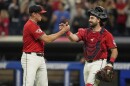 Cleveland Guardians relief pitcher Cade Smith left, shakes hands with catcher Austin Hedges, right, after the Guardians defeated the Chicago White Sox.