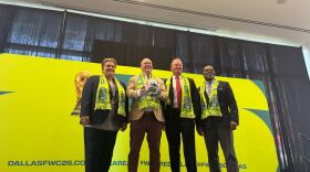 From left, Monica Paul, Dan Hunt, Jeff Cheney and Michael Evans pose for a photo at a FIFA World Cup news conference.