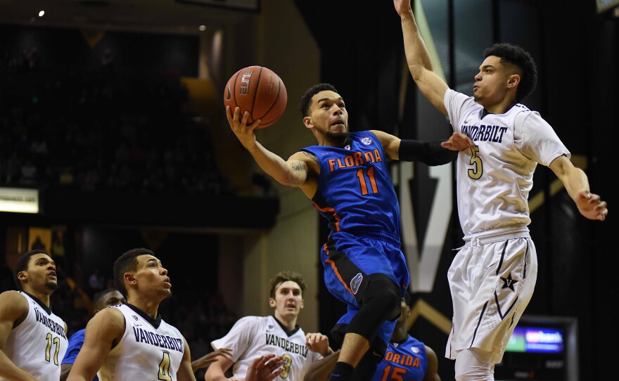 Three Vanderbilt defenders look on as Florida's Chris Chiozza (11) goes up against Matthew Fisher-Davis (5) in the second half. Chiozza was one of three Gators to score in double figures, netting 10 points. (Greenberry Taylor/WUFT News)