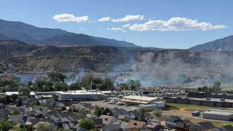 The Willow fire burns near houses in North Rifle in the afternoon on June 10. As of the evening of June 10, the area is under an evacuation order.