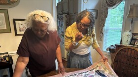 Linda Dixon and Kim Dixon Derouchey look over the first in a series of story quilts they are working on.