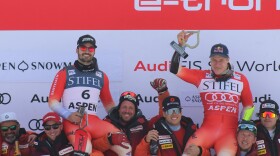 Swiss ski racers Loïc Meillard (left) and Marco Odermatt (right) celebrate their top results in a World Cup giant slalom race at Aspen Mountain on March 2. Odermatt won the event, and Meillard finished in second. (Kaya Williams/Aspen Public Radio)