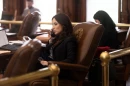 A woman speaks on a phone at her desk in the Texas Capitol.