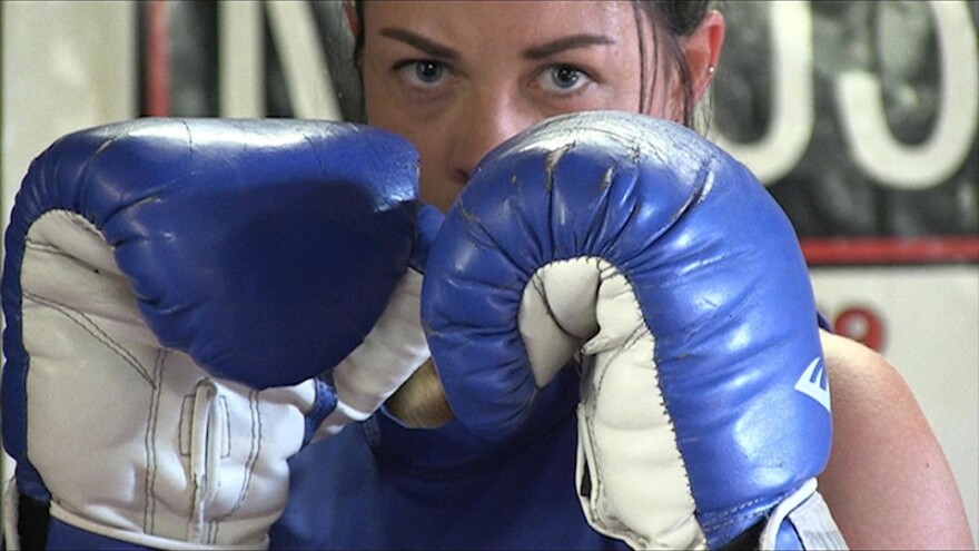 A video still of boxer Debra Rush from Nanette Boileau's video exhibit, "American Dreamers: Un-Alienable Rights."