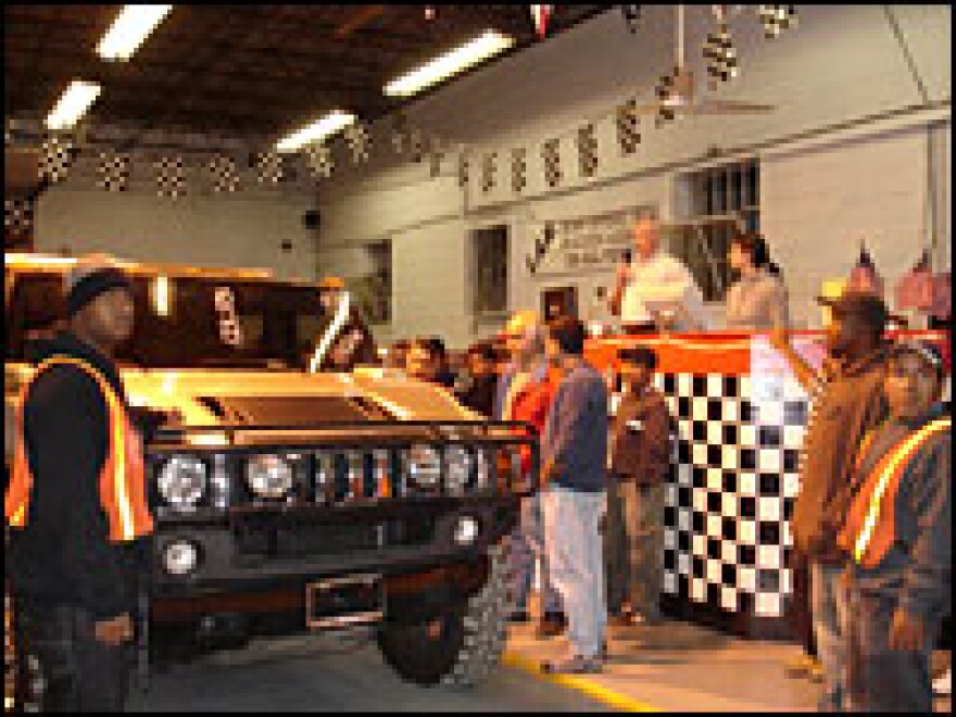 A Hummer H2 rolls into the warehouse where Bill Johns holds his weekly Tuesday night repo auctions.  The winning bid on this SUV was $10,000, well below its blue book value.