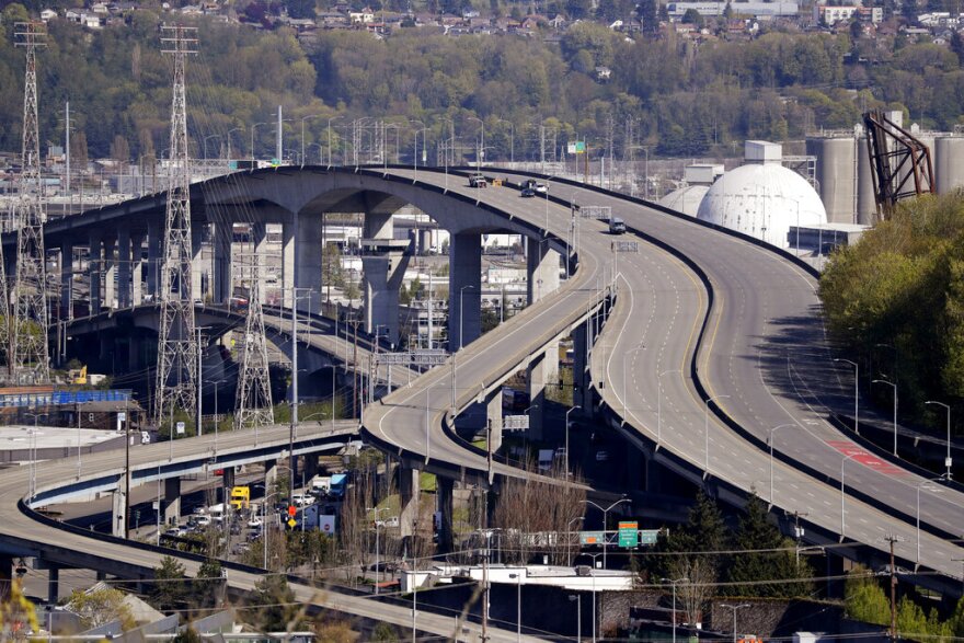 Several work vehicles are parked atop the West Seattle Bridge following an emergency closure several weeks earlier, Wednesday, April 15, 2020, in Seattle. The bridge, a 590-foot long span that arches 140 feet above the Duwamish Waterway, remained closed to traffic Sept. 17, 2022. The bridge is the city's busiest with an average of 100,000 vehicles and 25,000 transit riders daily before the coronavirus pandemic dramatically decreased traffic.