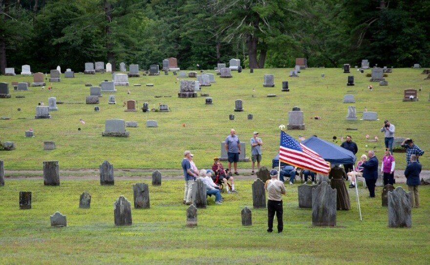 Attendees gather for the placing of a marker on the grave of Anthony Morse, a Boston Tea Party Participant, at Pine Hill Cemetery in Sharon, Vt., on Monday, Aug. 17, 2026. The Boston Tea Party Ships & Museum and Revolution 250 have placed about 70 markers on the graves of Boston Tea Party participants over the last four years, Jonathan Lane, Executive Director of Revolution 250, said. (Valley News photo)