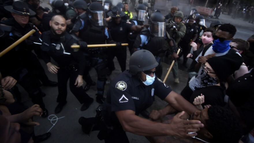 Police officers and demonstrators get into a scuffle during a protest that took place in May, over the killing over George Floyd and police brutality.