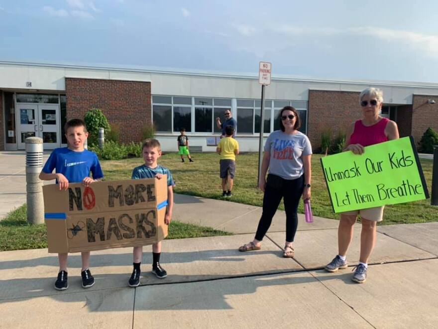 Students and parents protest masks outside the Williamsville school board meeting Tuesday