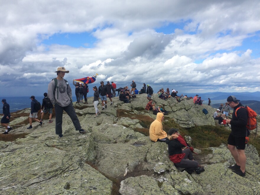 A crowd of hikers on the summit of Mt. Mansfield