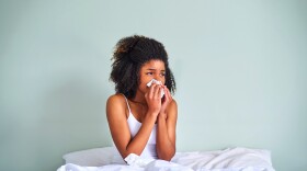 Woman with allergies in bed.