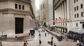 Investors are spending billions of dollars to align their portfolios with their personal values. But there's little agreement on what exactly qualifies — or disqualifies — an investment option from being marketed as sustainable. Above, pedestrians walk past the New York Stock Exchange on June 10.