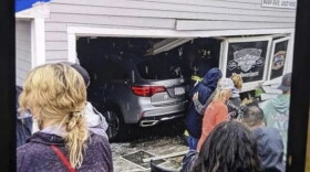 In this photo released by the Laconia Fire Department, a vehicle sits inside a restaurant after crashing through the wall on Sunday, July 2, 2023, in Laconia, NH. The car struck the busy Looney Bin Bar & Grill and injured more than a dozen patrons inside, authorities said.