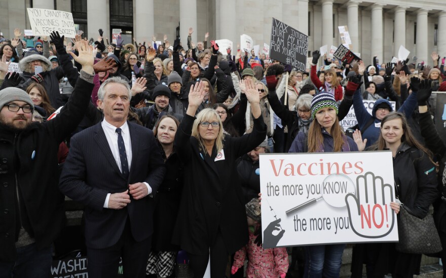 Robert F. Kennedy, Jr. stands with protesters.