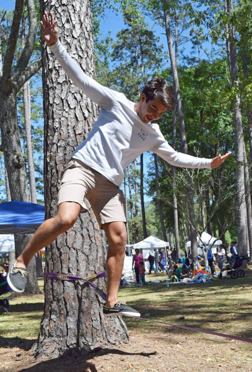 John Nieves balances on a slackline. (Diana Illingworth/WUFT News)