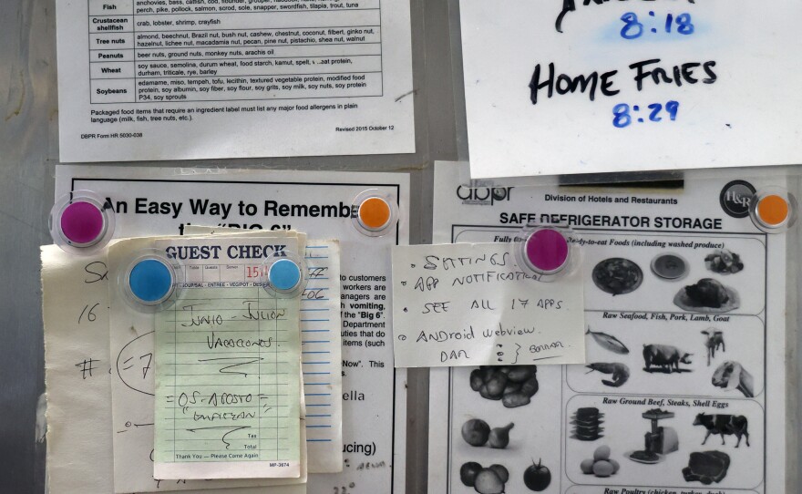 Reminders and inventory counts hang from a fridge during the Sunday morning rush at 16th Avenue Diner in Gainesville, Fla. on Sunday, Nov. 16, 2025.