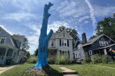 A blue tree sits in front of a Wooster home. 
