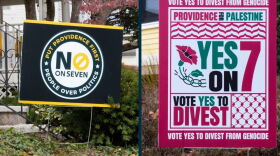 Campaign signs opposing and supporting Providence’s Question 7 are displayed ahead of the Nov. 3 election. The ballot measure would restrict city investments in companies and countries tied to certain human rights abuses, including genocide and military occupation. Credit: Audrey Hammond/ Ocean State Media