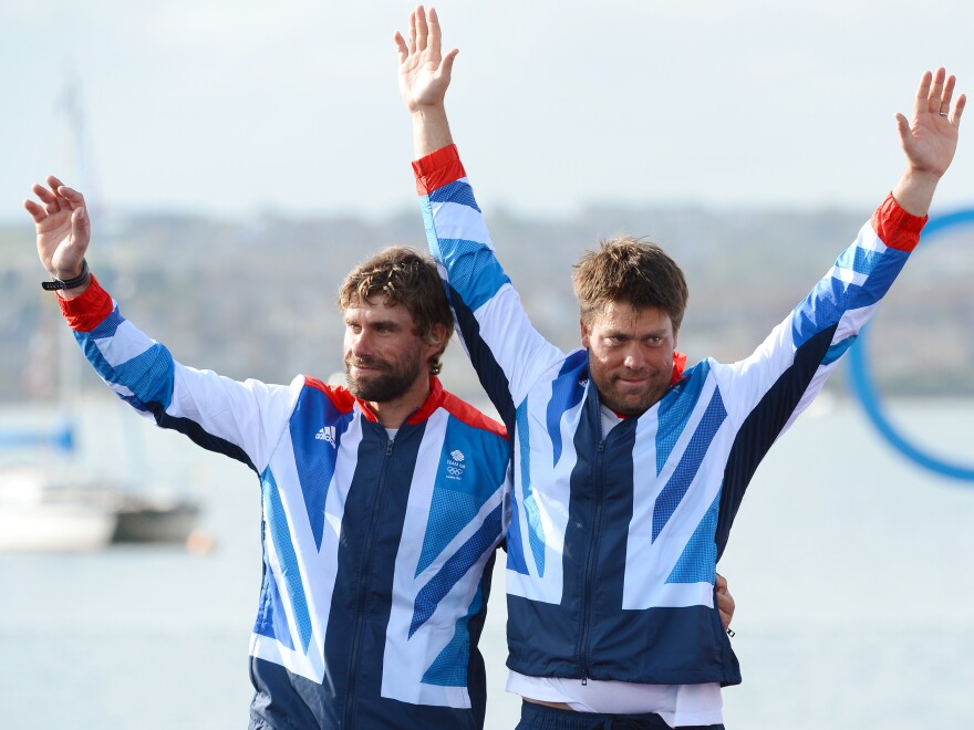 Andrew 'Bart' Simpson stands to the left of fellow sailor Iain Percy at the London 2012 Olympic Games.