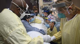 Critical care nurses and respiratory therapists flip a COVID-19 patient upright in North Memorial's South Six and South Seven Intensive Care Units on Monday, Dec. 7, 2020 at North Memorial Health Hospital in Robbinsdale, Minn. Hospitals in Michigan and Minnesota on Tuesday, Nov. 16, 2021, reported a wave of COVID-19 patients not seen in months as beds were filled with unvaccinated people and health care leaders warned that staff were being worn down by yet another surge.