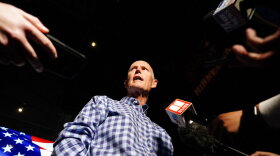 Sen. Rick Scott, R-Fla., speaks to the media after a campaign rally for Republican candidates for U.S. Senate Sen. Kelly Loeffler and Sen. David Perdue on Friday, Nov. 13, 2020, in Cumming, Ga. (AP Photo/Brynn Anderson)