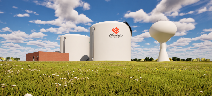 A brick building with two large white water silos and a water tower