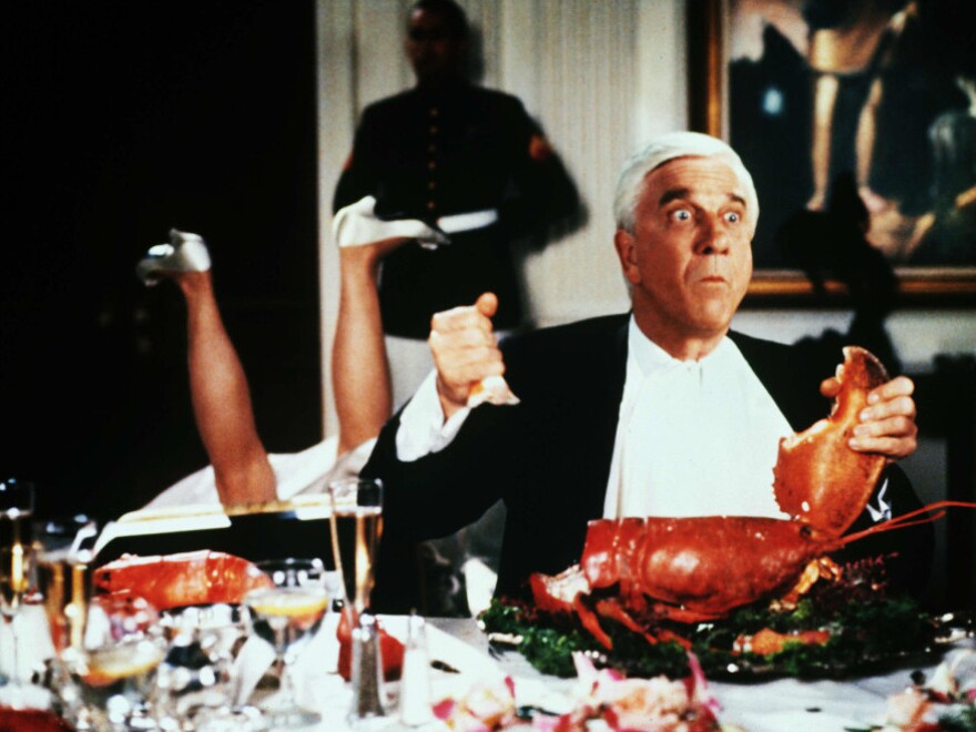 Leslie Nielsen takes a bite out of crime in <em>Naked Gun 2 1/2 — The Smell Of Fear</em>.
