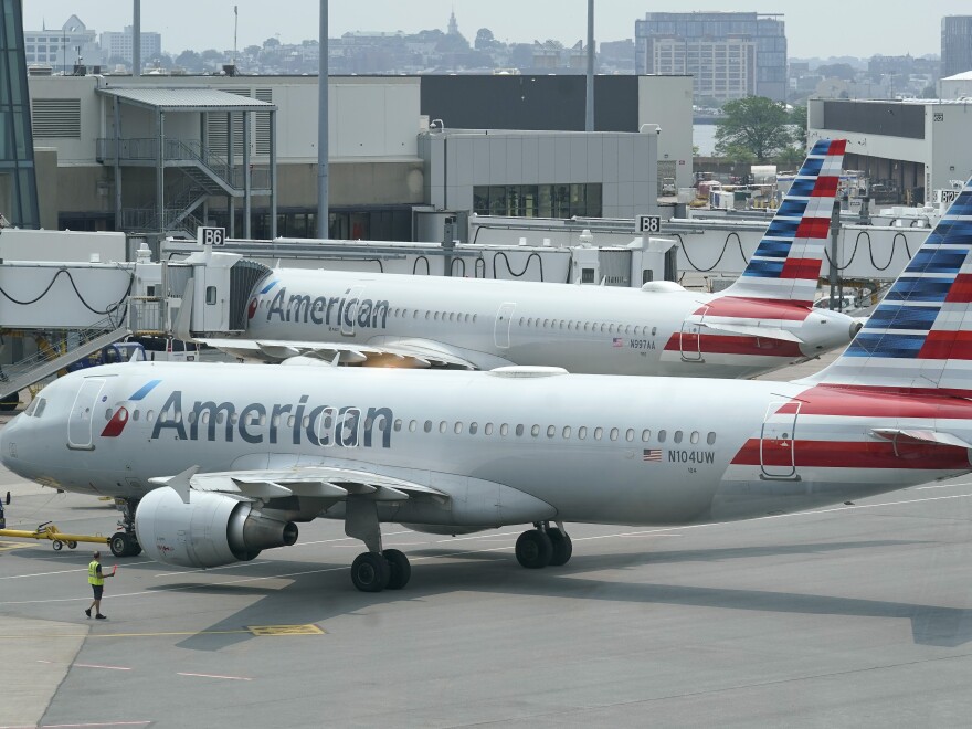 American Airlines passenger jets prepare for departure near a terminal at Boston Logan International Airport, in Boston in July. More than 1,000 flights were cancelled this weekend due to weather and staffing shortages, the airline said.