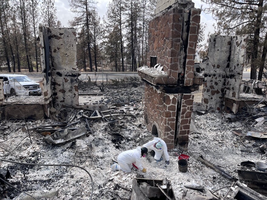 Archaeologists from the Alta Heritage Foundation sift through the rubble of CaitLynn and Keenan Burt's Spokane home.