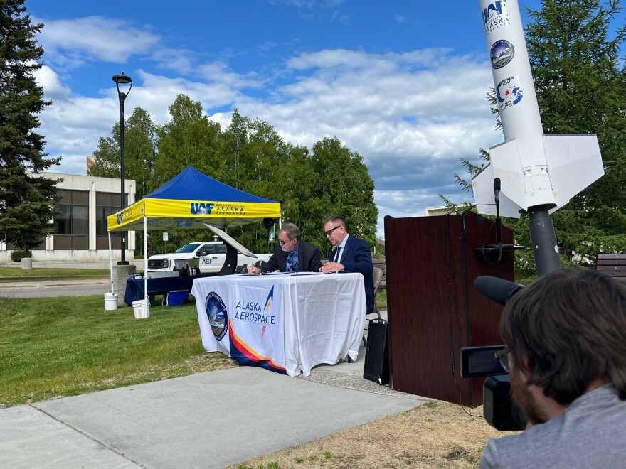 McCoy, left, and Oberst sign the memorandum of agreement that outlines how the Geophysical Institute and Alaska Aerospace will help promote each other and the launch facilities they operate.