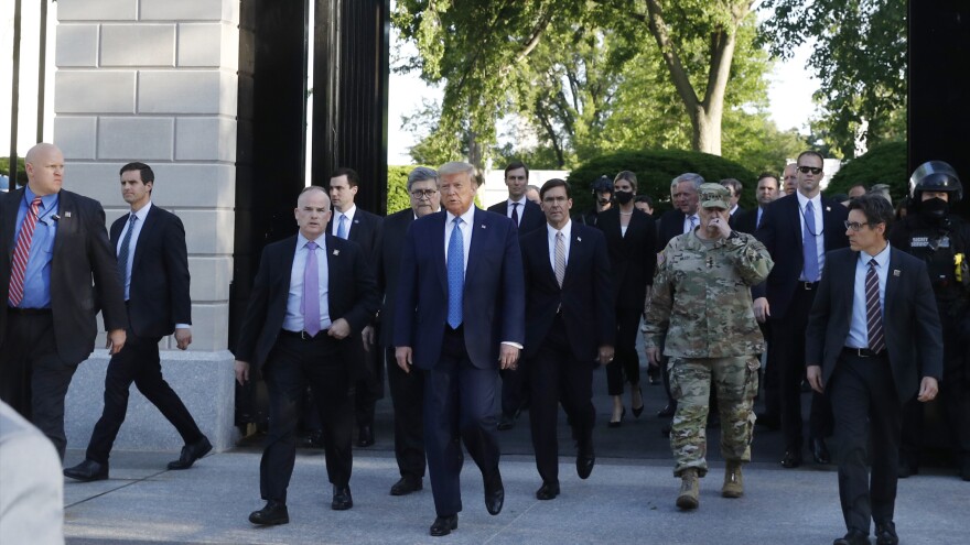 President Trump exits the gates of the White House Monday evening to visit St. John's Church across Lafayette Park.