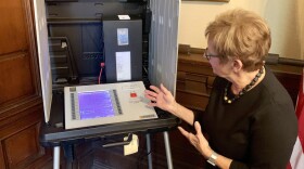 Former Indiana Secretary of State Connie Lawson demonstrates a voter-verifiable paper audit trail on a voting machine.