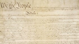 This photo made available by the U.S. National Archives shows a portion of the first page of the United States Constitution. (National Archives via AP)